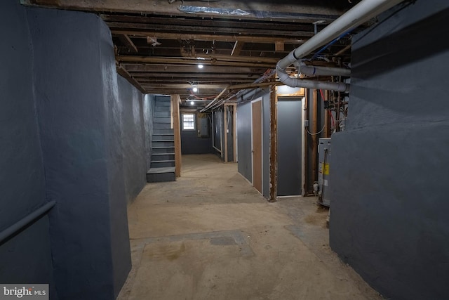 basement featuring electric panel and gas water heater