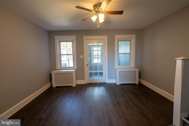 doorway with dark hardwood / wood-style flooring, radiator, and ceiling fan