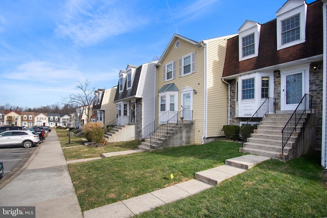 multi unit property featuring a front lawn