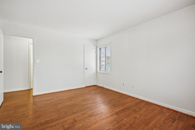 empty room with hardwood / wood-style flooring