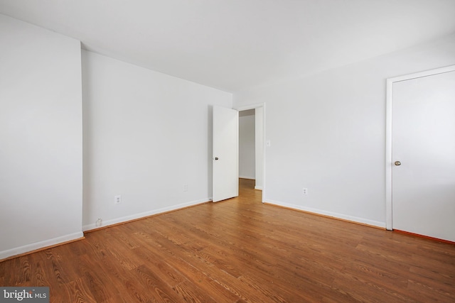 unfurnished room with wood-type flooring