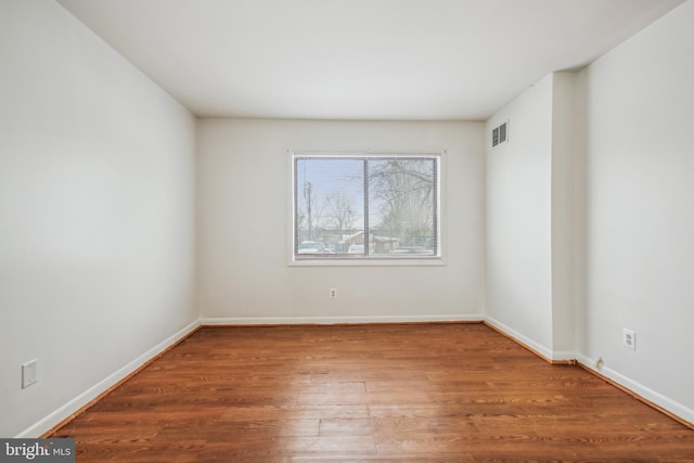 spare room featuring wood-type flooring