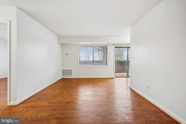 spare room with wood-type flooring