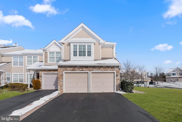 view of front of house featuring a front yard and a garage