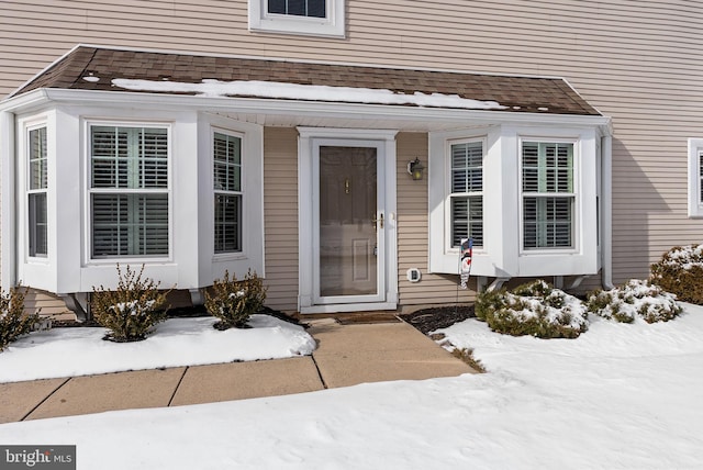 view of snow covered property entrance