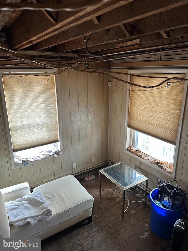 bedroom featuring multiple windows and wooden walls