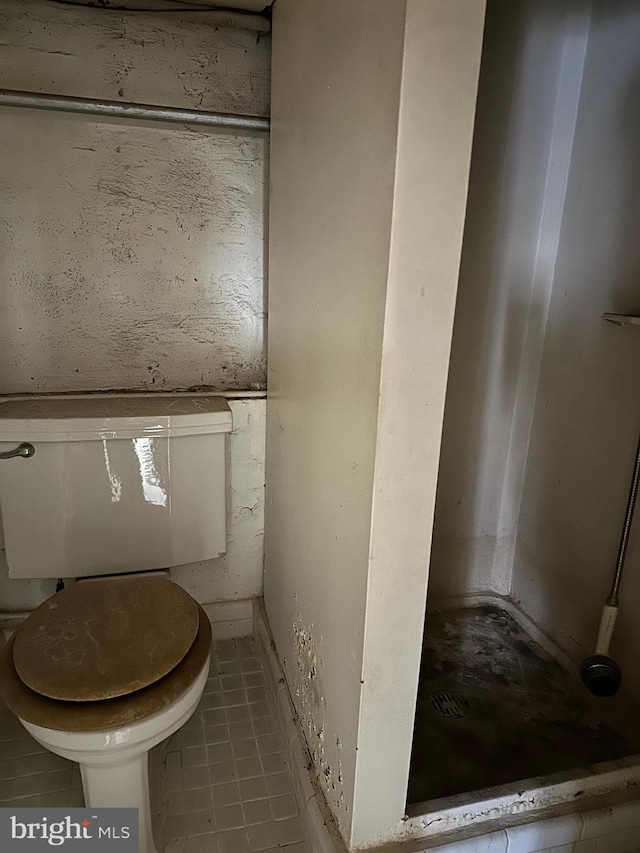 bathroom with tile patterned floors and toilet