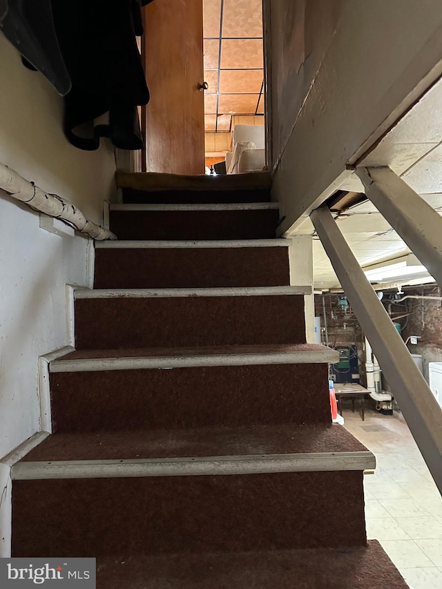 staircase featuring tile patterned flooring