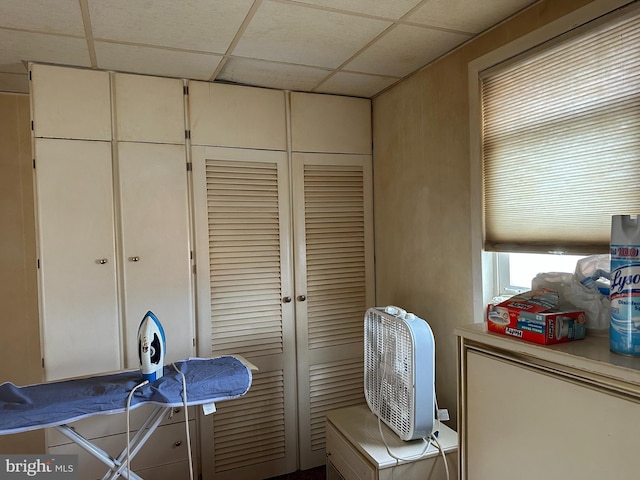 interior space featuring a paneled ceiling and a closet