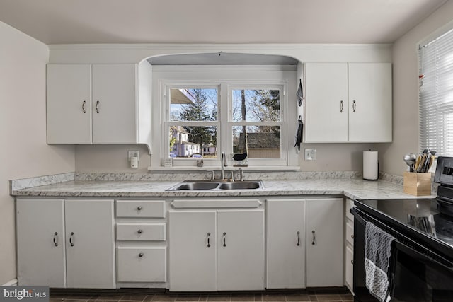 kitchen featuring sink, white cabinetry, black electric range oven, and a wealth of natural light