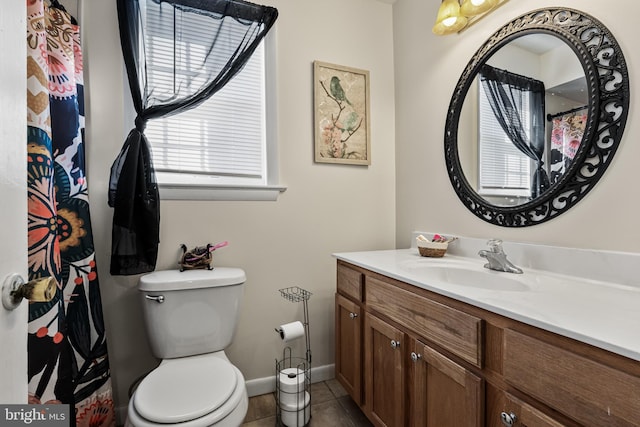 bathroom with toilet, tile patterned flooring, and vanity