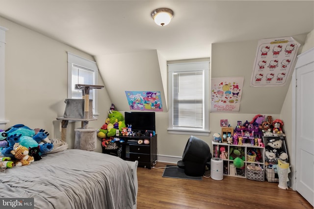 bedroom featuring lofted ceiling and hardwood / wood-style flooring