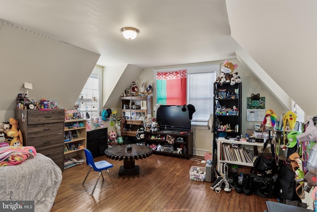 bedroom featuring hardwood / wood-style floors and vaulted ceiling