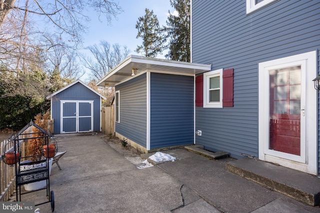 view of side of property with a storage unit