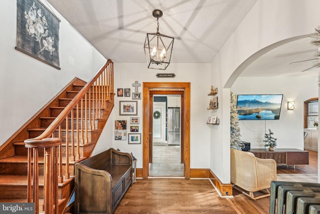 entrance foyer featuring hardwood / wood-style flooring and a notable chandelier