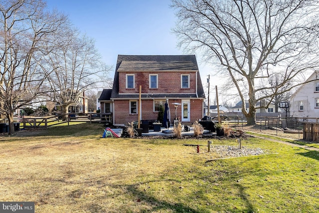 back of house featuring a lawn and a patio