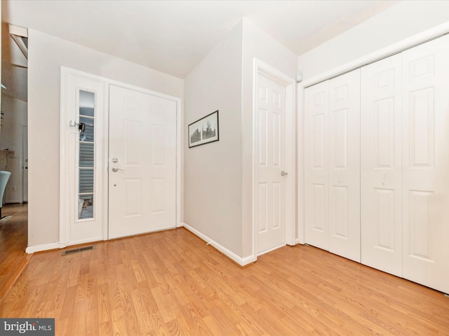 foyer entrance with light wood-type flooring