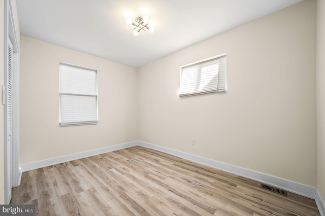 unfurnished room with light hardwood / wood-style flooring