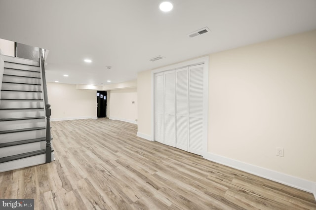 basement with light hardwood / wood-style floors