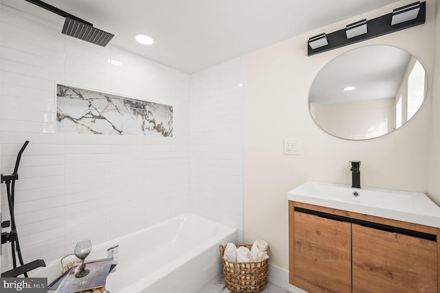 bathroom featuring vanity and tiled shower / bath