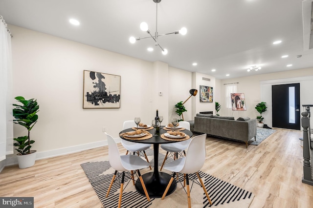 dining area featuring a chandelier and light hardwood / wood-style floors