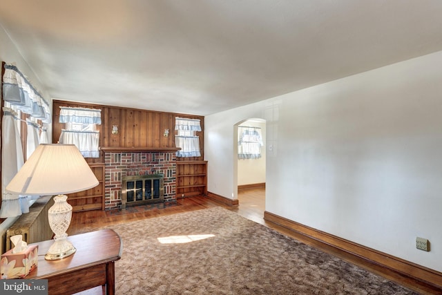 living room featuring a brick fireplace and hardwood / wood-style floors