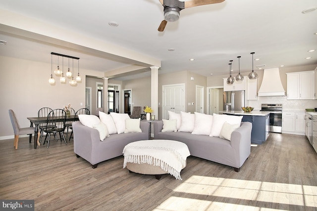 living room featuring ceiling fan and light wood-type flooring