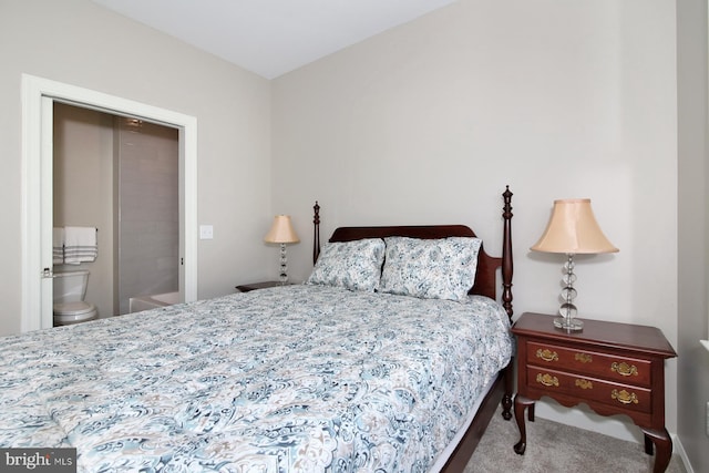 bedroom featuring carpet and ensuite bathroom