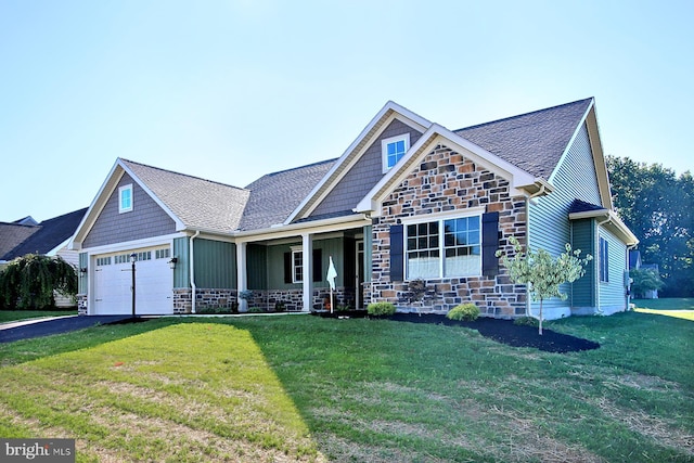 craftsman-style house featuring a garage and a front lawn