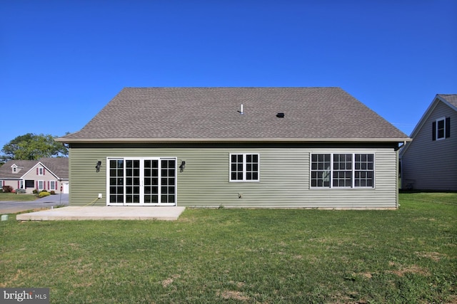 back of house featuring a patio area and a yard