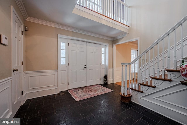 entrance foyer featuring crown molding