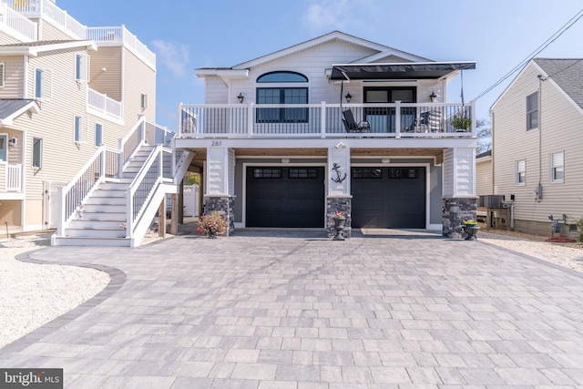 view of front of property with central AC unit and a garage