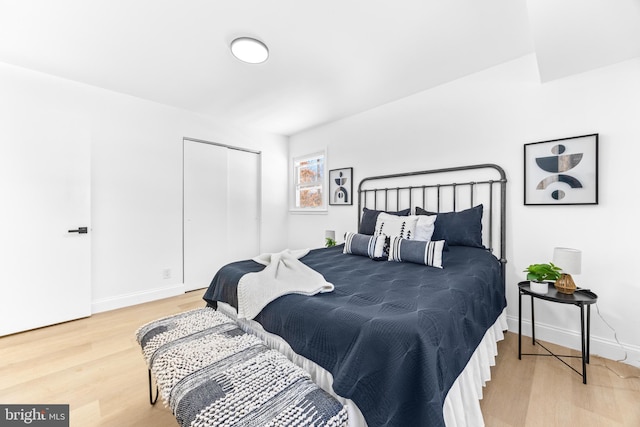 bedroom with hardwood / wood-style flooring and a closet