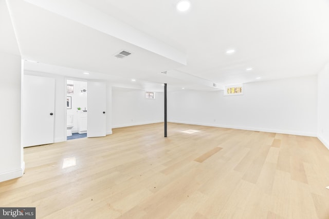 basement with light hardwood / wood-style floors