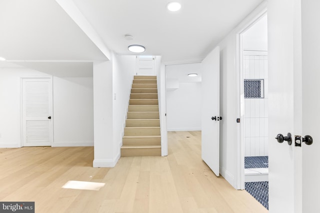 stairs featuring hardwood / wood-style flooring