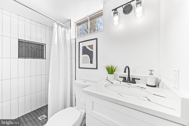 bathroom with vanity, toilet, and curtained shower