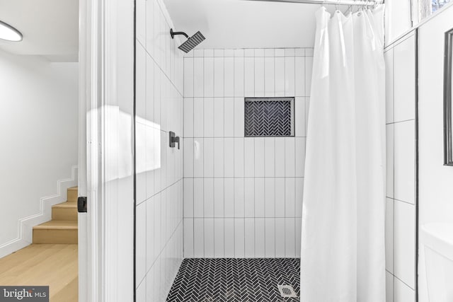 bathroom with hardwood / wood-style flooring and a shower with curtain