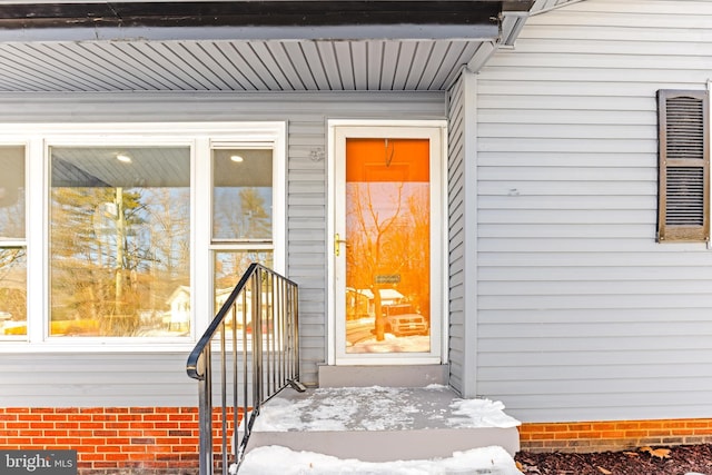 view of snow covered property entrance