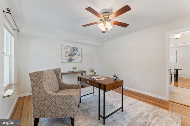 home office featuring a wealth of natural light, ceiling fan, and wood-type flooring