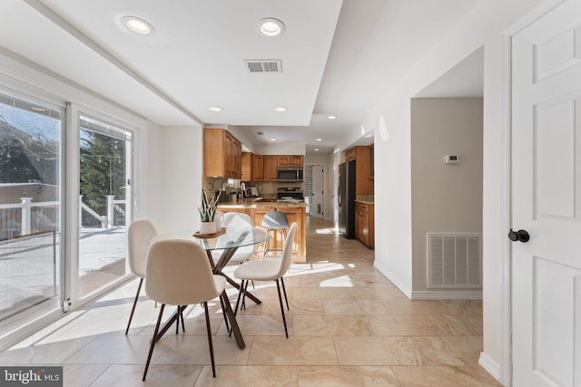 dining space featuring light tile patterned floors