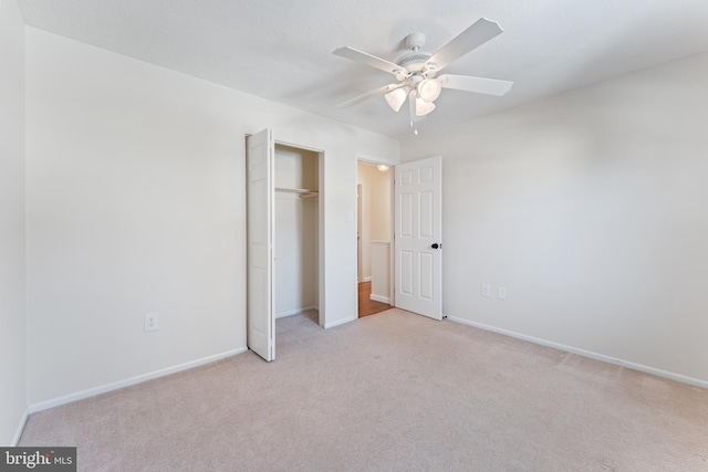 unfurnished bedroom with a closet, ceiling fan, and light colored carpet