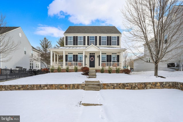 colonial home featuring covered porch