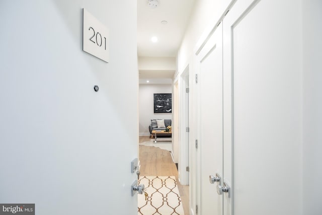 hallway with hardwood / wood-style flooring