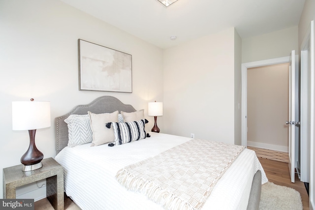 bedroom with wood-type flooring