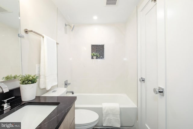 full bathroom featuring toilet, tiled shower / bath combo, and vanity