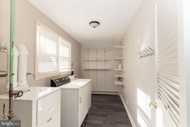 clothes washing area featuring washer and dryer, a healthy amount of sunlight, a baseboard radiator, and dark hardwood / wood-style floors