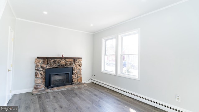 unfurnished living room featuring baseboard heating, light hardwood / wood-style floors, ornamental molding, and a stone fireplace