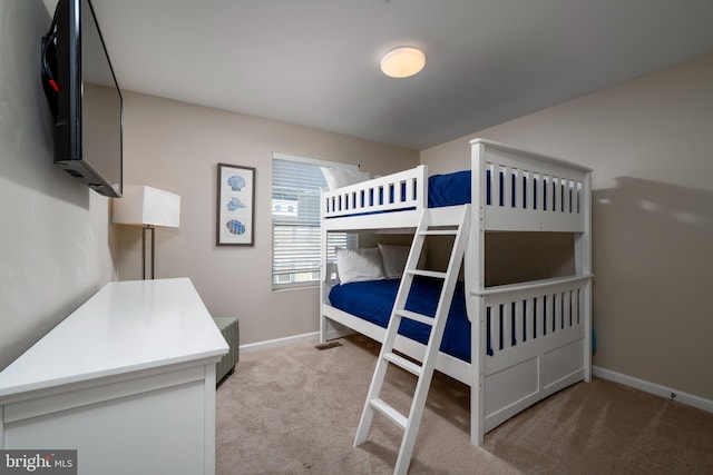 bedroom featuring light carpet