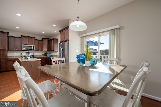 dining space with light hardwood / wood-style flooring