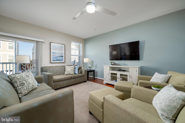 living room featuring ceiling fan and light hardwood / wood-style floors